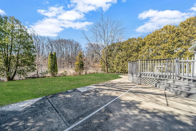 view of patio with a wooded view and a wooden deck