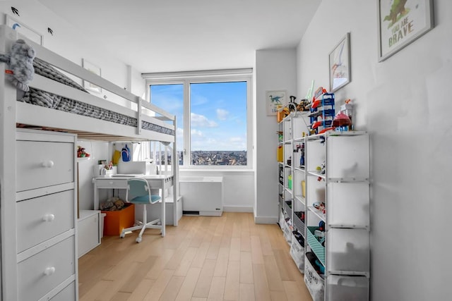 office space with light wood-type flooring and baseboards