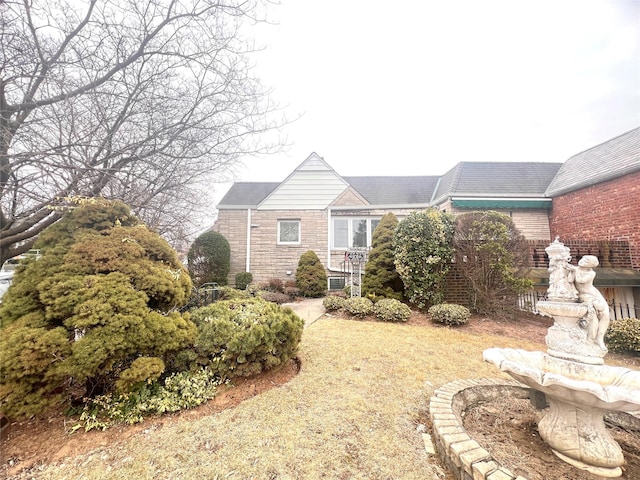 rear view of property featuring stone siding