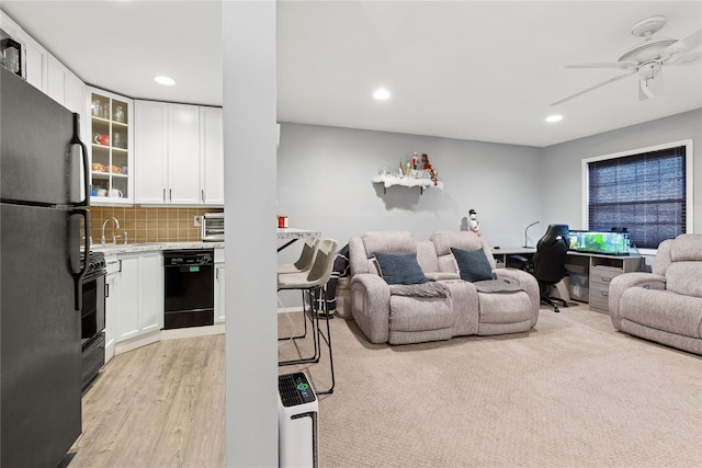 living room featuring a ceiling fan, recessed lighting, and light wood finished floors