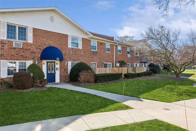 view of front facade featuring a front yard and brick siding