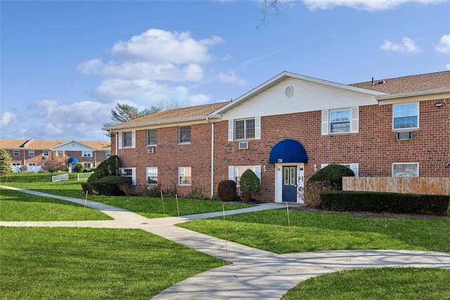 view of front of home with brick siding and a front yard