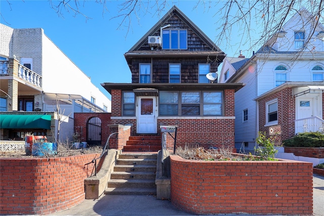 view of front facade featuring brick siding and entry steps