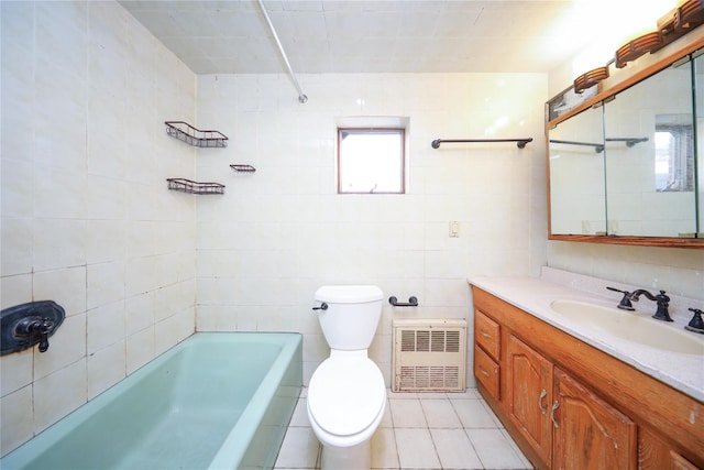 full bath featuring vanity, tile walls, toilet, a bathtub, and tile patterned floors