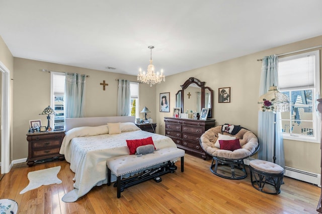 bedroom featuring wood-type flooring, visible vents, a notable chandelier, and baseboard heating