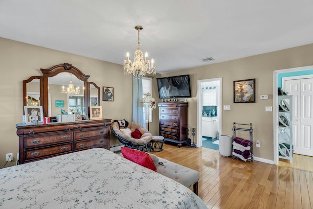 bedroom featuring a baseboard radiator, visible vents, multiple windows, and hardwood / wood-style flooring