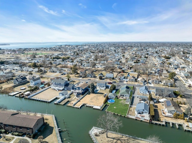 drone / aerial view with a water view and a residential view