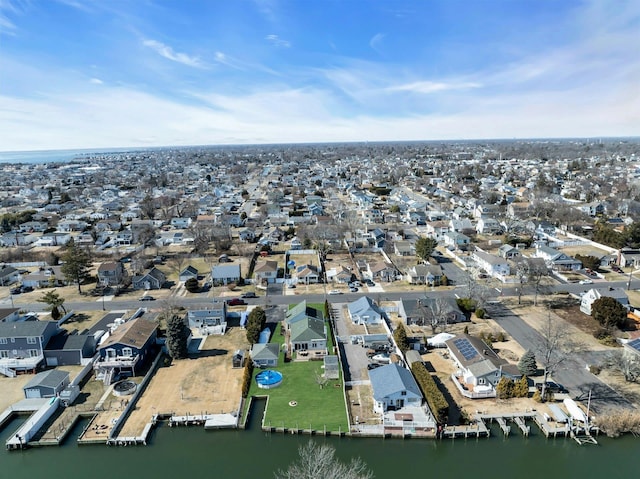 drone / aerial view with a water view and a residential view