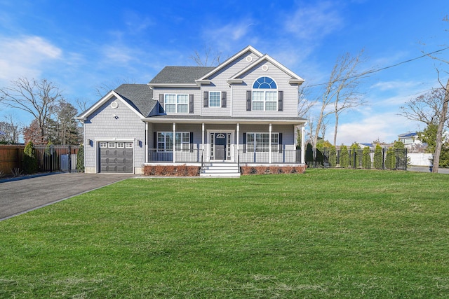 view of front facade with aphalt driveway, a porch, a front yard, and fence