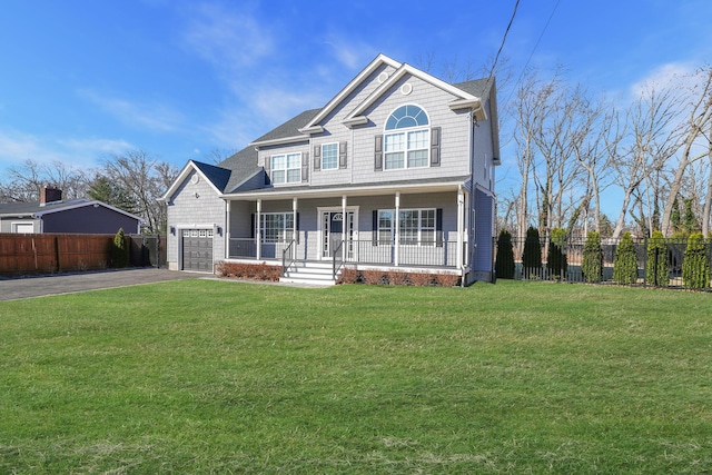 view of front facade featuring covered porch, driveway, a front lawn, and fence