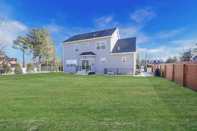 back of property featuring a yard and a fenced backyard