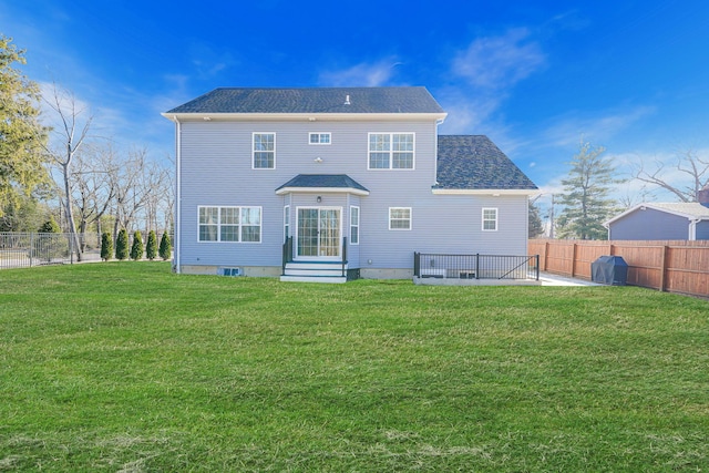 rear view of house with a patio, a lawn, a fenced backyard, and entry steps