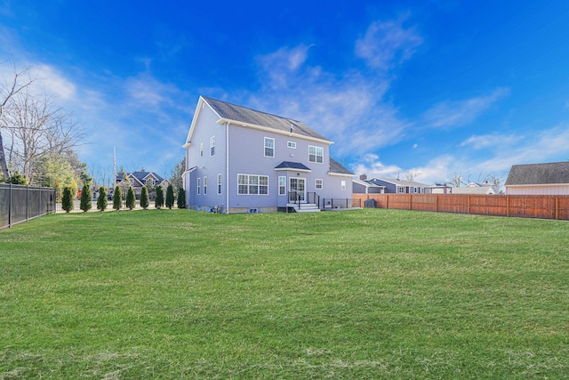 back of property featuring a lawn and a fenced backyard