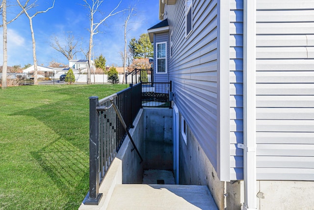 deck with a lawn and fence