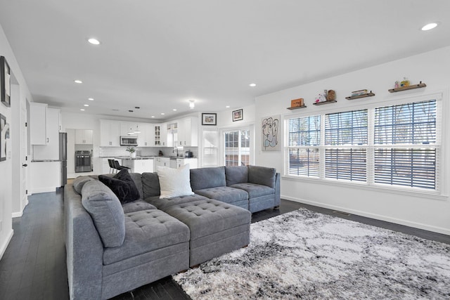 living area with recessed lighting, baseboards, and dark wood-style floors