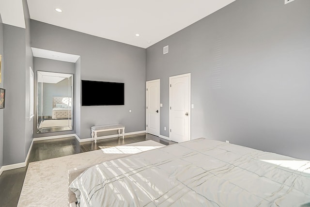 bedroom with recessed lighting, baseboards, and wood finished floors