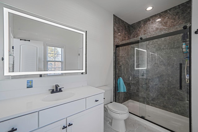 bathroom featuring toilet, marble finish floor, recessed lighting, a shower stall, and vanity