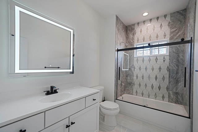 full bath with shower / bath combination with glass door, vanity, and toilet