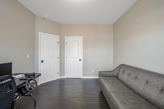 home office featuring baseboards and dark wood-type flooring