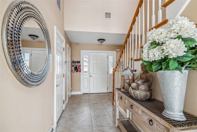 entrance foyer featuring stairs, light tile patterned floors, baseboards, and visible vents