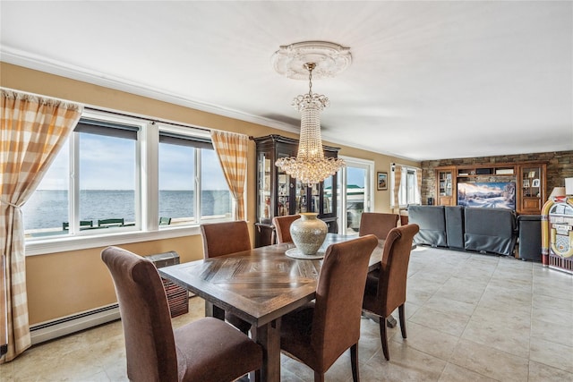 dining space with a water view, ornamental molding, an inviting chandelier, light tile patterned flooring, and a baseboard radiator