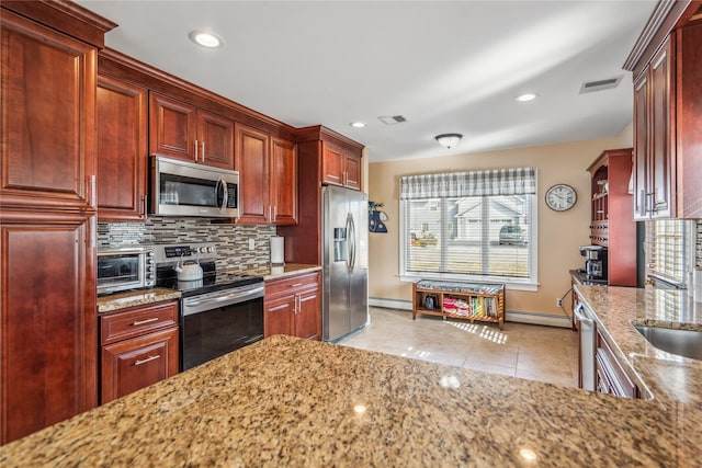 kitchen with light tile patterned floors, light stone countertops, visible vents, and stainless steel appliances