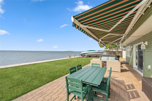 view of patio / terrace with a water view and outdoor dining space