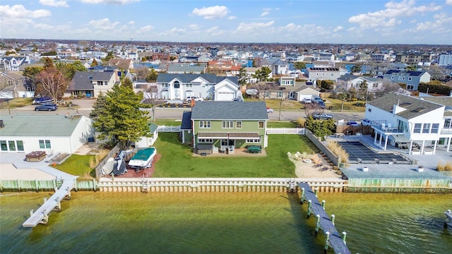 drone / aerial view with a residential view and a water view