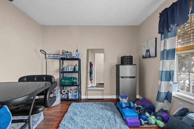 interior space featuring wood finished floors and baseboards