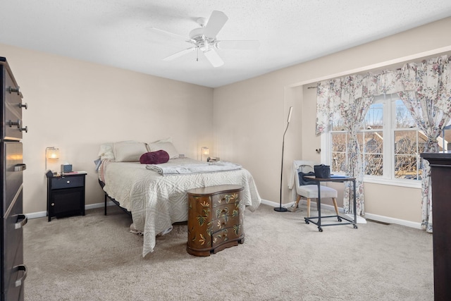 carpeted bedroom featuring baseboards and a ceiling fan