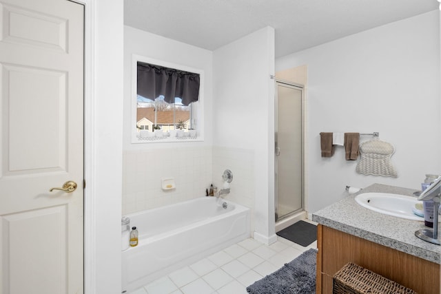 full bath featuring a stall shower, vanity, a bath, and tile patterned floors