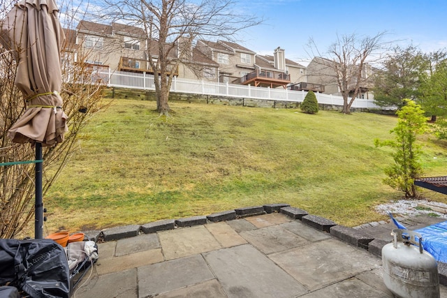 view of yard featuring a residential view, a fenced backyard, and a patio