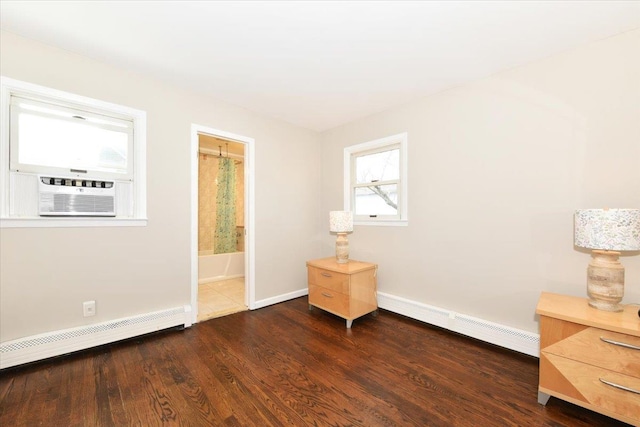 interior space featuring dark wood-type flooring, a baseboard radiator, cooling unit, and baseboards