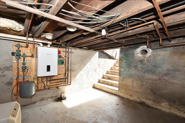 unfinished basement featuring tankless water heater and stairs