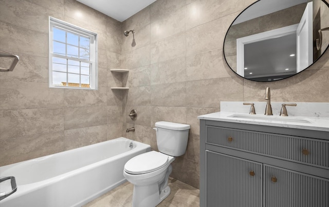 bathroom featuring toilet, vanity, tile walls, and bathing tub / shower combination