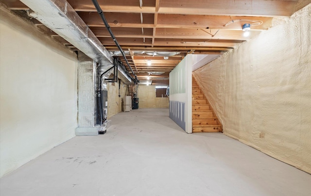 unfinished basement featuring heating unit