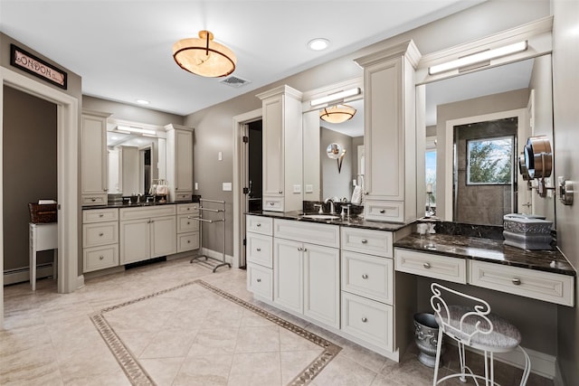 bathroom featuring a sink, baseboards, two vanities, and recessed lighting