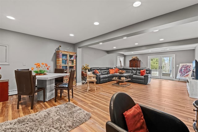 living area with recessed lighting, a baseboard heating unit, wood finished floors, and french doors