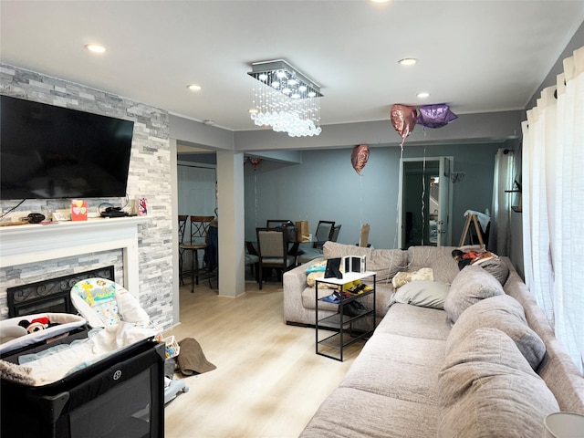 living room with a fireplace, wood finished floors, and recessed lighting