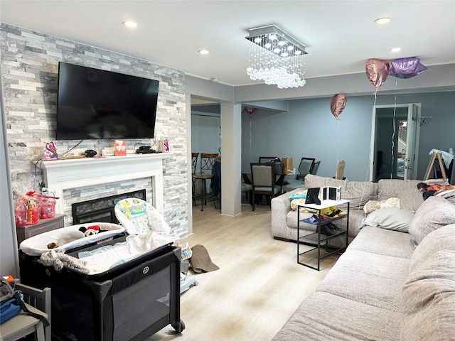 living area featuring a large fireplace, wood finished floors, and recessed lighting