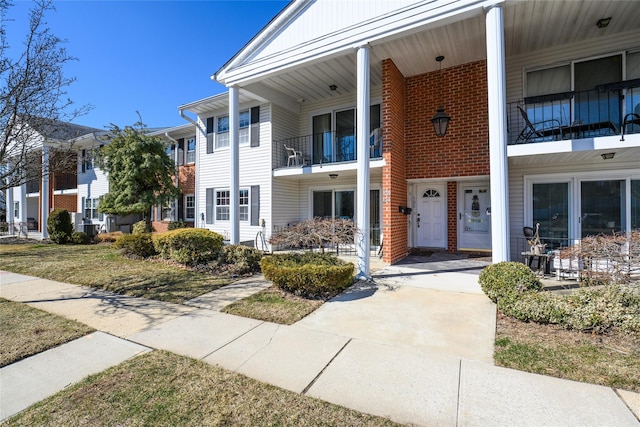 townhome / multi-family property featuring brick siding