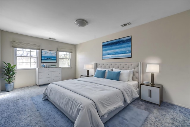 carpeted bedroom featuring baseboards and visible vents