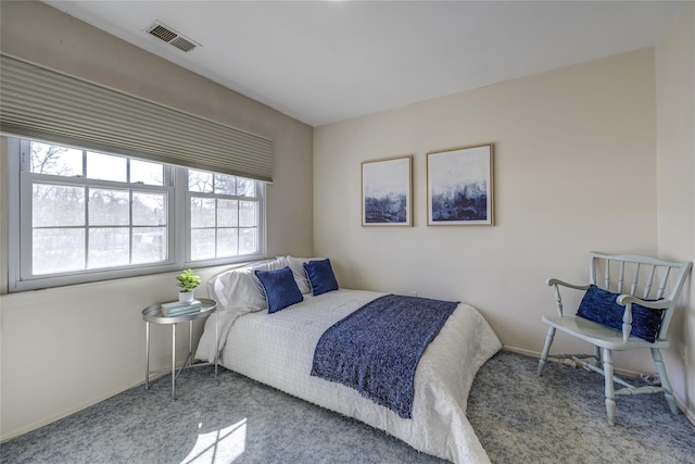 carpeted bedroom featuring visible vents and baseboards