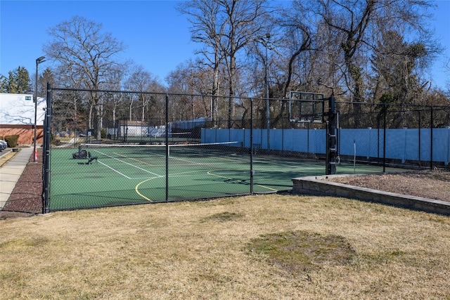 view of sport court with a yard, community basketball court, and fence