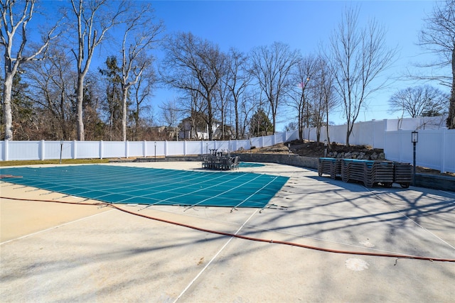 view of swimming pool with a fenced in pool, a fenced backyard, and a patio