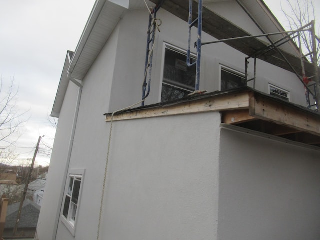 view of side of property featuring stucco siding