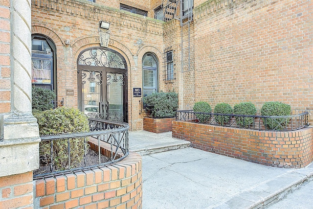 doorway to property with brick siding