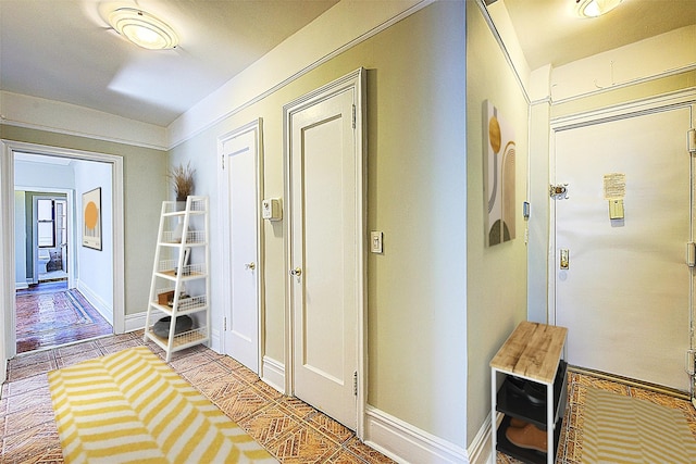 hall featuring baseboards