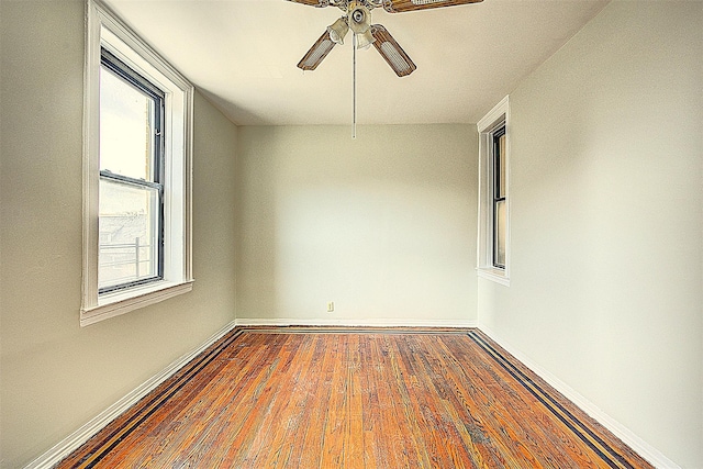 empty room featuring ceiling fan, wood finished floors, and baseboards