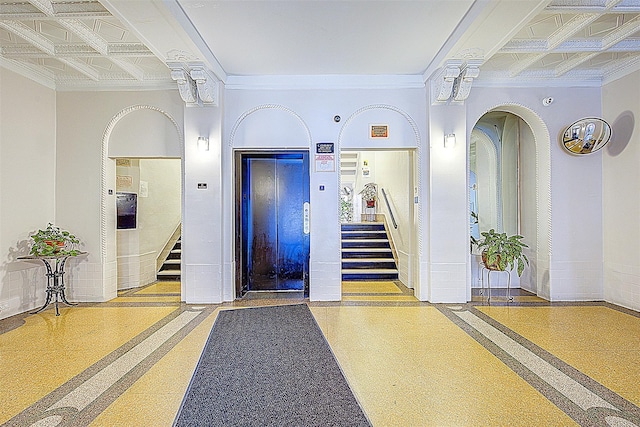 building lobby with stairs and ornamental molding